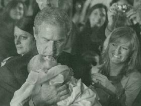 President Bush holds snowflake baby, Trey Jones
